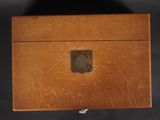 an old wooden box sitting on top of a black surface