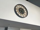 a clock on the wall above a doorway in a room