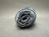 a close up of a rolled up blue towel on a table