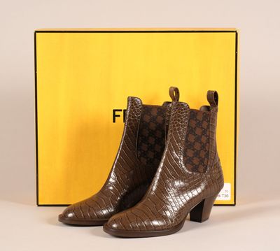une paire de bottines marron avec une boîte en arrière-plan