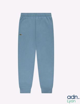 a baby boy ' s blue sweat pants with a small logo on the side