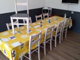 a table and chairs in a room with a clock on the wall