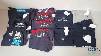 a lot of t - shirts that are on the table