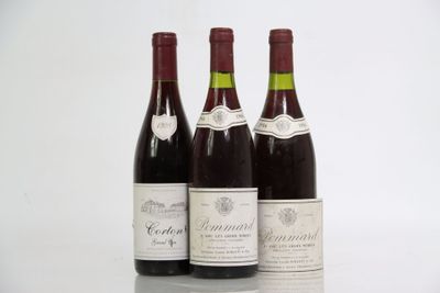 three bottles of wine are lined up on a table
