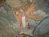 a painting of a man standing on a bridge in the mountains