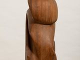 wooden sculpture of a man ' s torso on a white pedestal