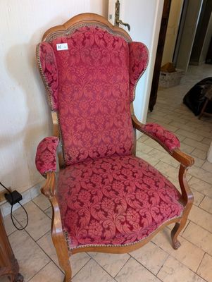 a red chair that is sitting in the corner of a room