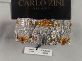 a close up of a bracelet with orange and white stones