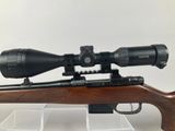 a close up of a rifle with a scope on it