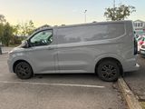 the silver van is parked in the parking lot next to other cars