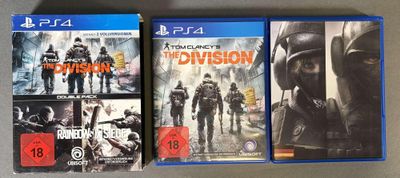 deux jaquettes de jeux vidéo représentant la division et la division posée sur une table