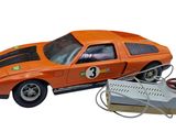 an orange toy car with a remote control on it