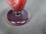 a vase that has a red and white design on it