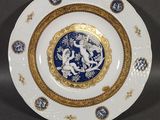an image of a blue and white plate with a gold border