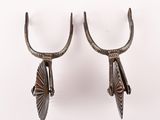 pair of antique silver plated horns on hooks on a white background