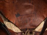 a brown leather hat with a leather bow on top of it