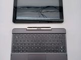 a laptop and a tablet on a table next to each other