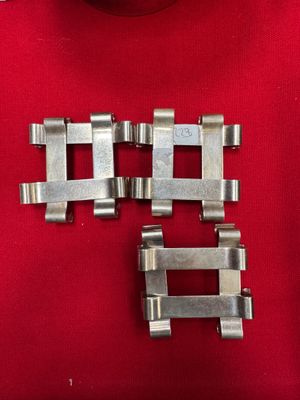 two pieces of metal are sitting on a red cloth