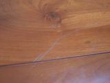 a close up of a wooden table with a knife and fork on it