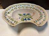 a white bowl with blue flowers on it on a table
