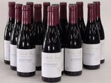 six bottles of wine are lined up in a row on a table
