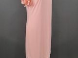 a pink dress on a mannequin stand against a gray background