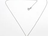 un gros plan d'un collier composé d'une pierre violette montée sur une chaîne