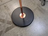 a lamp that is on a table with a black base