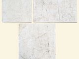 trois feuilles de papier sur lesquelles figurent des dessins, posées sur une table