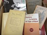 many books that are in a box on a table