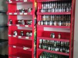 two red shelvings with bottles of beer on them
