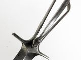 a metal spoon with a handle on a white surface