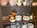 a china cabinet with a lot of dishes and cups on it