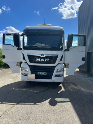 the truck is parked in front of a building on a sunny day
