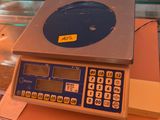 a scale on a table with a glass case in the background