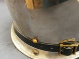 an image of a silver and gold helmet on a table