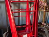 a red chair that is sitting on top of a trash can