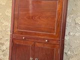 a wooden cabinet with a door on top of it