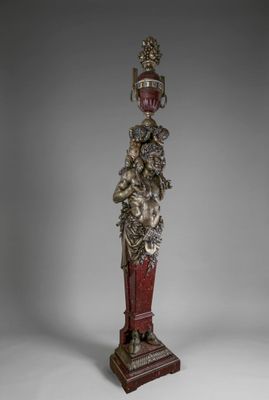 an antique statue of a man with a crown on his head