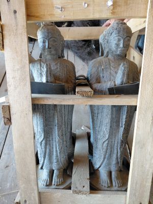 trois statues représentant des personnes, posées sur une étagère dans une pièce