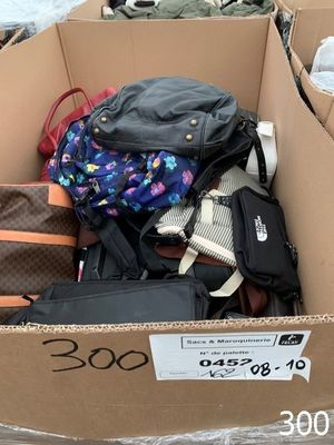 a cardboard box filled with lots of luggage on the street