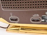 a brown and gold radio sitting on top of a table