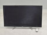 the flat screen television is sitting on a stand on the floor