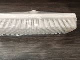a white brush on a table with a plastic bag