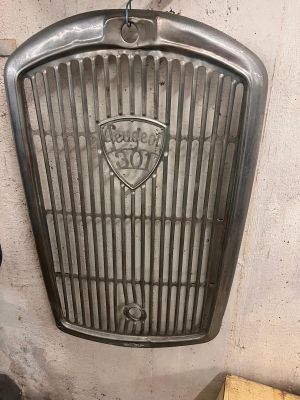 a metal grill on the wall of a building