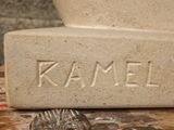 a stone statue with a name carved into it on a table