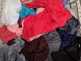 a basket full of clothes that is sitting on the floor