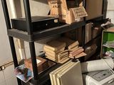a black shelving with a lot of boxes on top of it