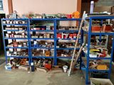many shelves with various items on them in a room