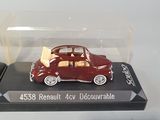 a red toy car in a clear case on a white surface